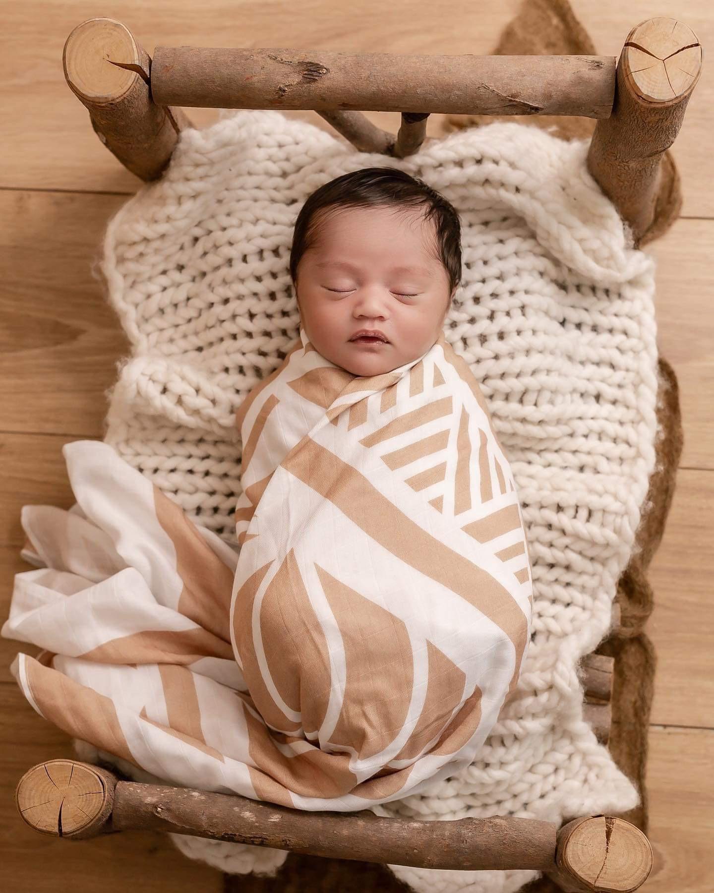 Sleeping Baby wrapped up in a Pele Blanket