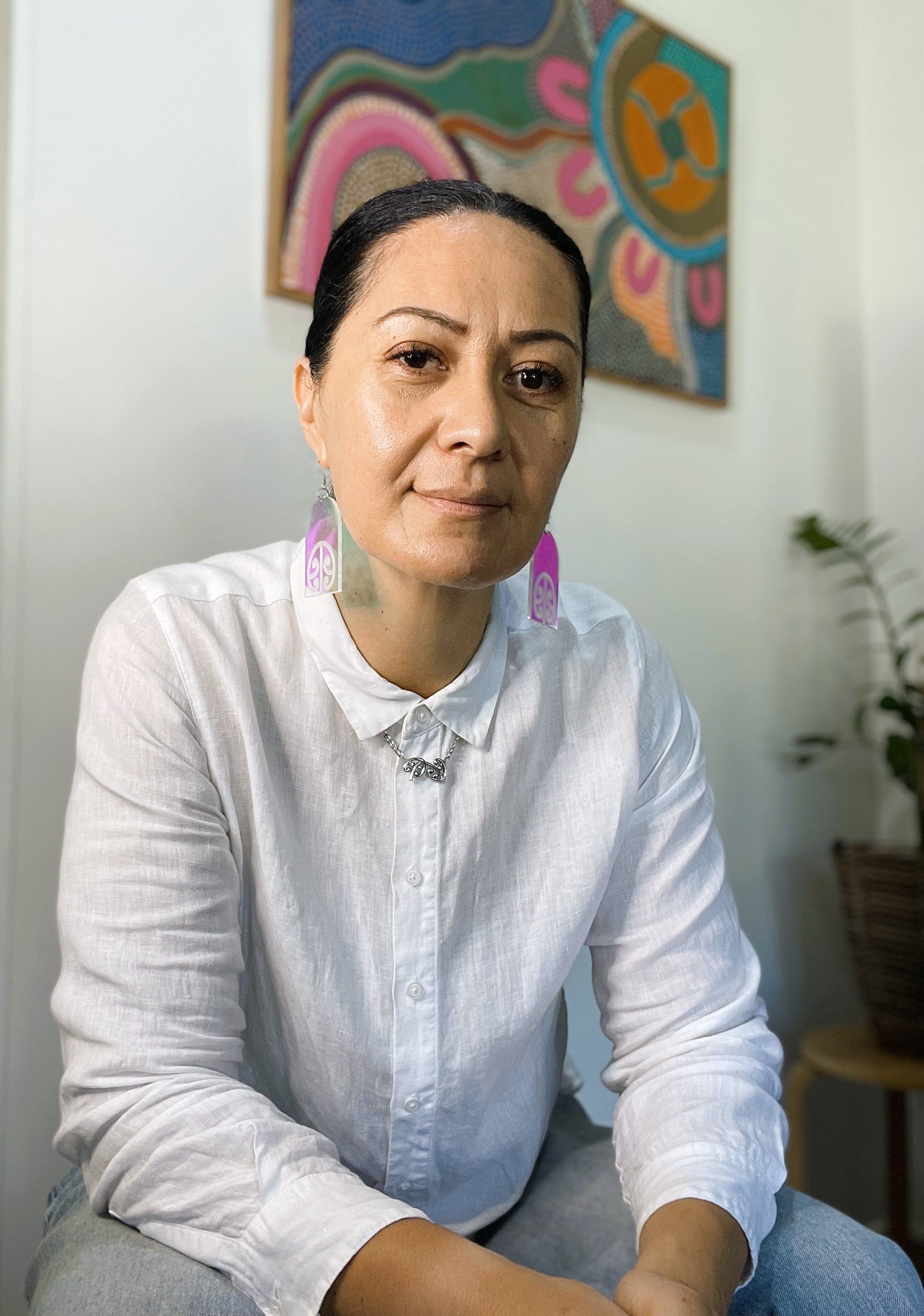 Woman wearing Maori inspired earrings