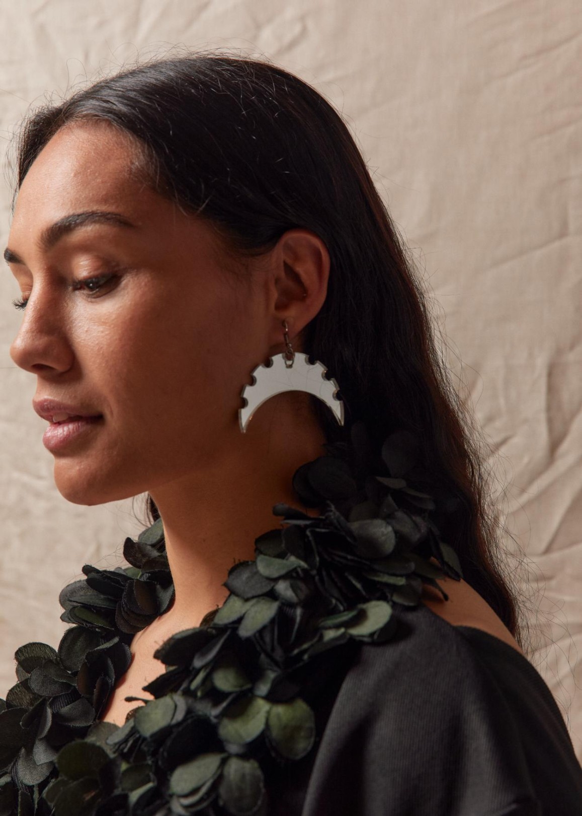 Pasifika Woman wearing maori inspired earrings 