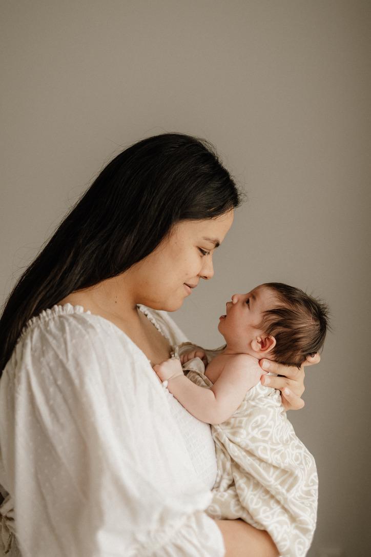 Mother and baby together wrapped in a baby wrap
