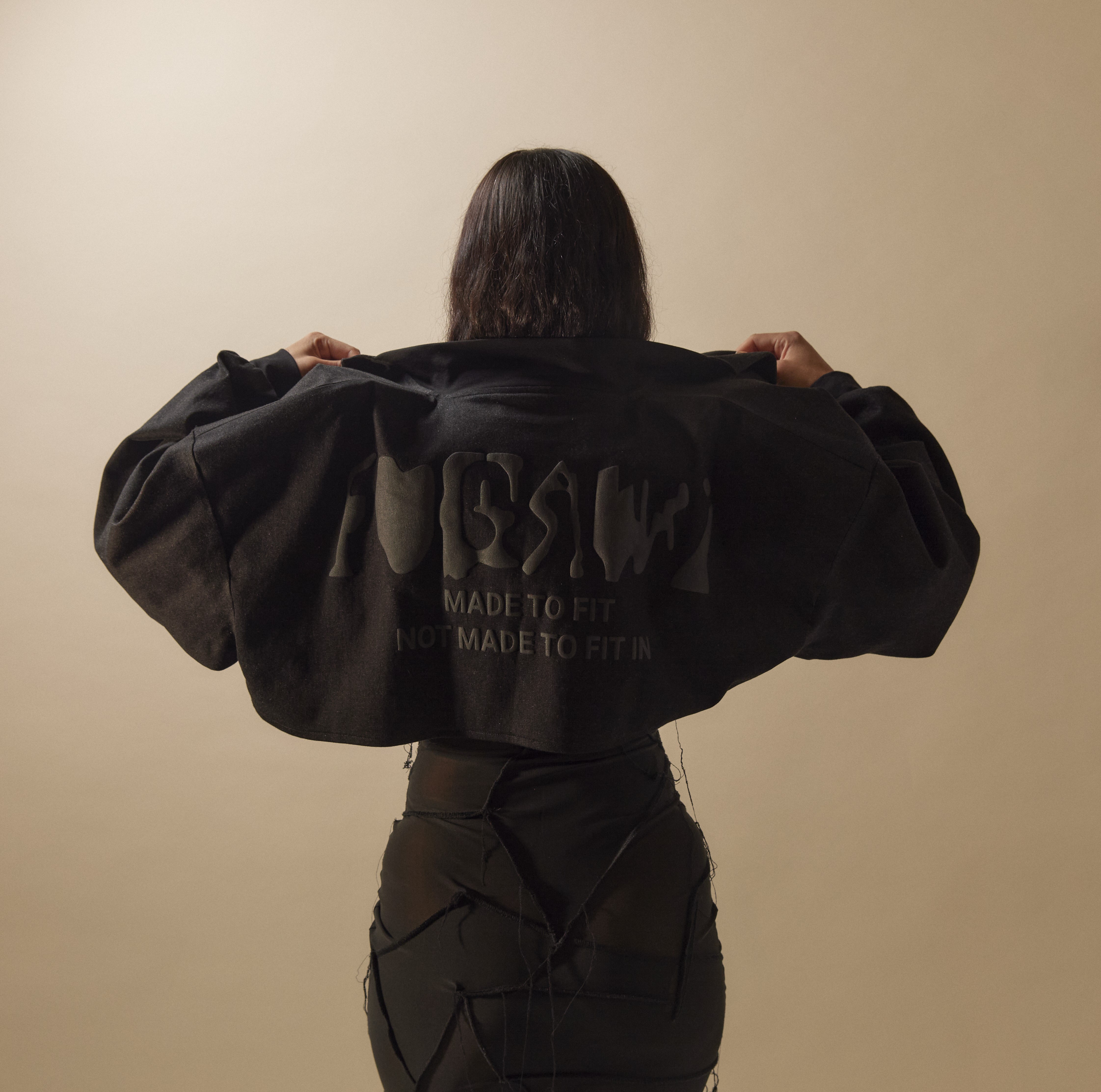 Woman wearing a black cropped jacket