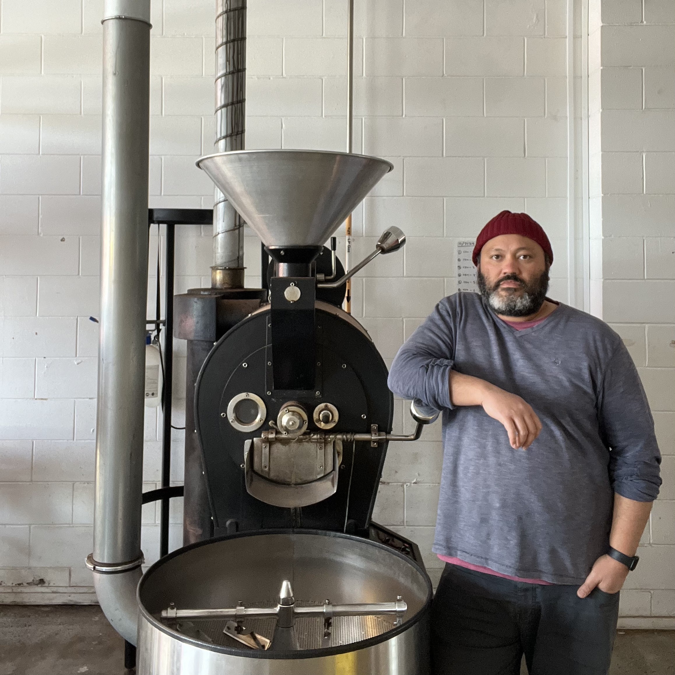 Man standing next to a commercial cooking machine