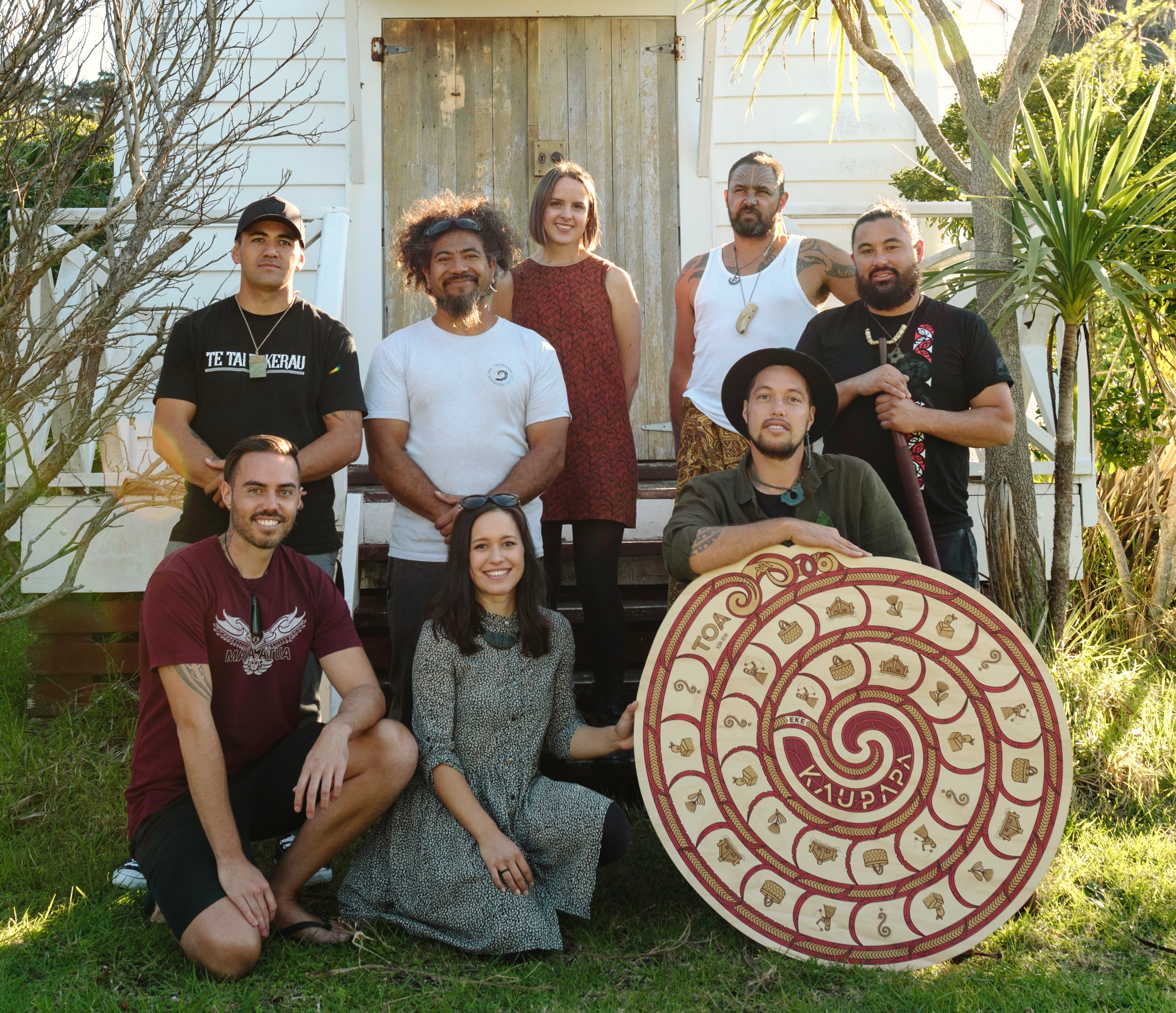 Group of POC holding a maori inspired board game